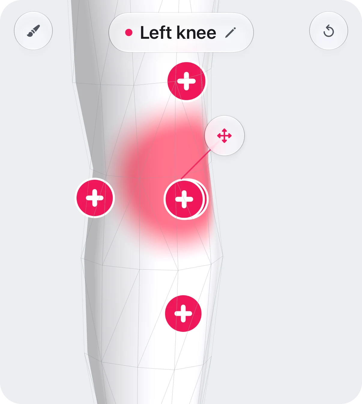 The area picker after a tap on the left knee: the knee shaded in the tracker’s colour, a ringed pin labelled Left knee where the finger landed, and plus markers for the knee’s parts.